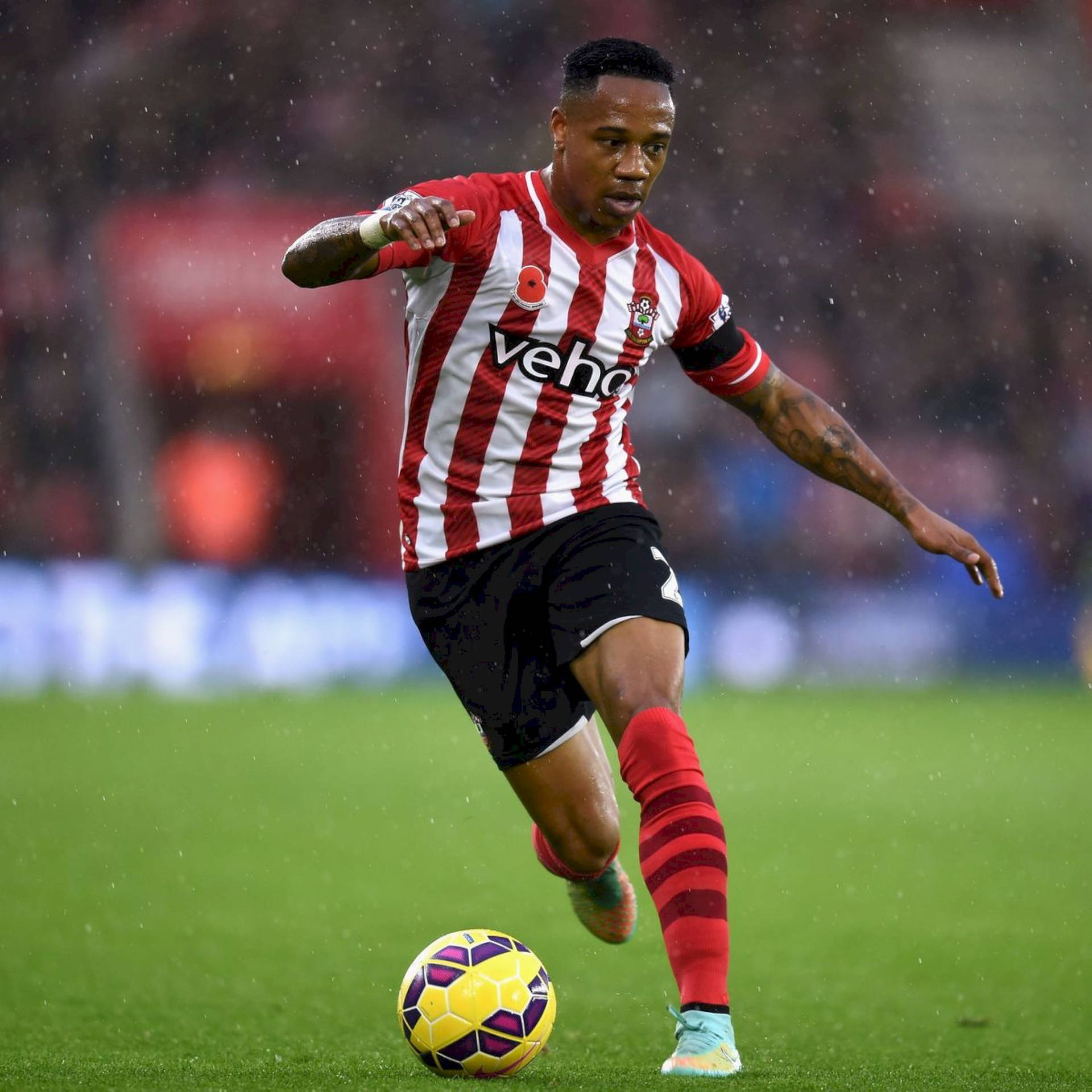 Nathaniel Clyne Kicking A Ball Background