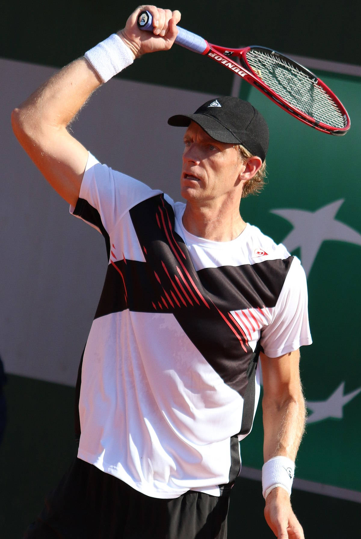 National Tennis Champion, Kevin Anderson, Poised For Action In-game With His Fierce Red Tennis Racket. Background