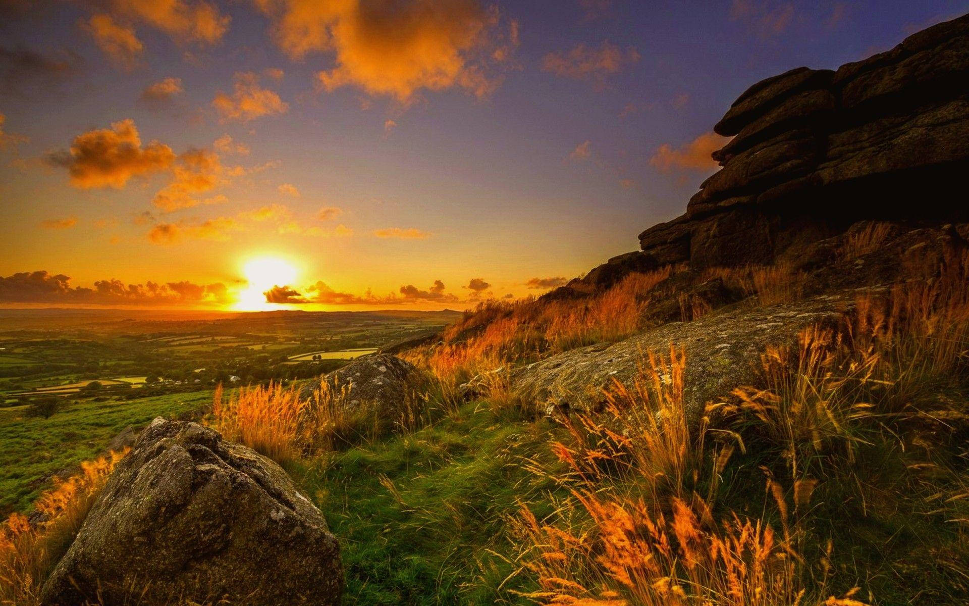 Natural Grassy Mountain Sunset Background
