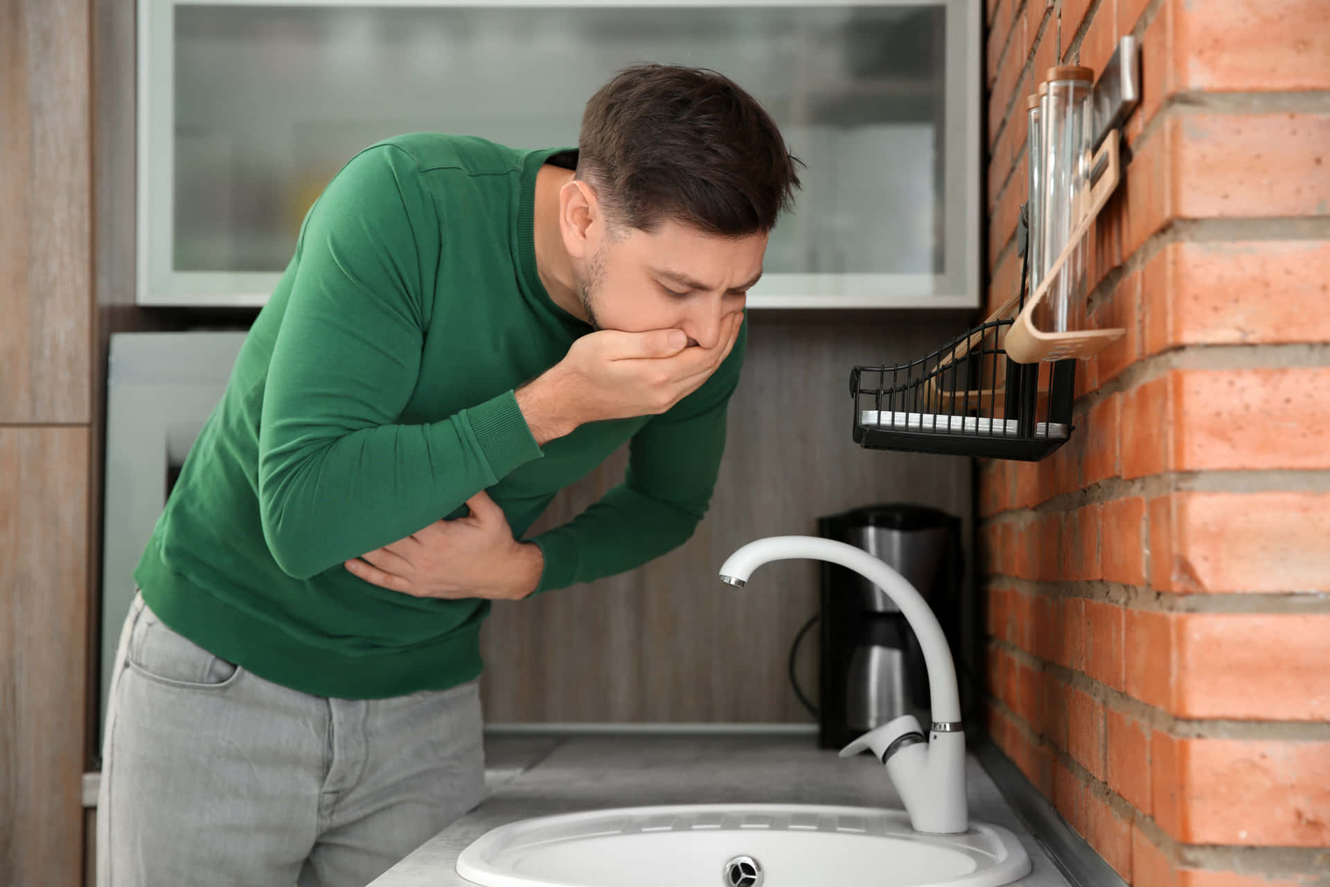 Nauseous Man In Green Sweater Background