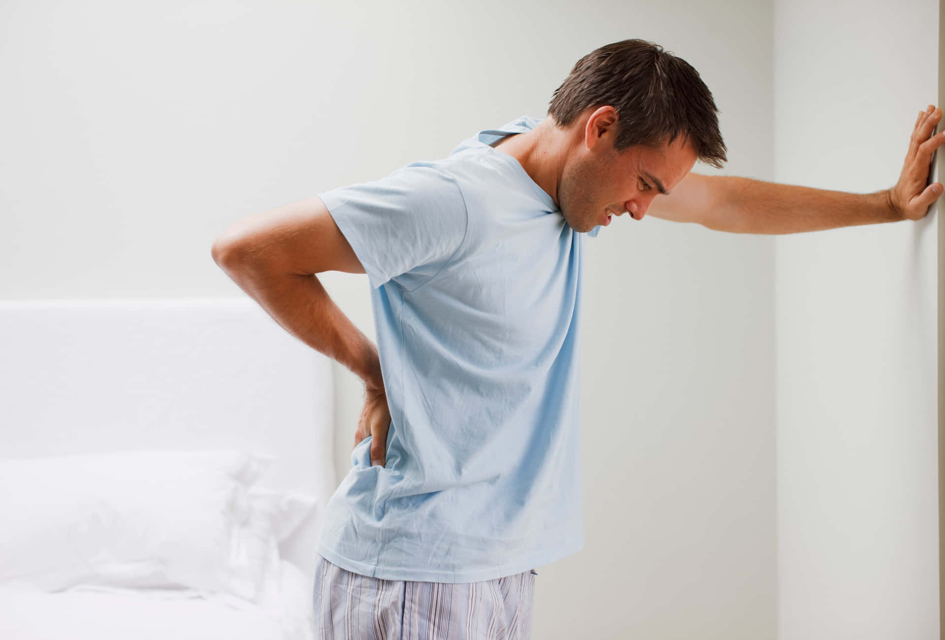 Nauseous Man In Light Blue Shirt Background