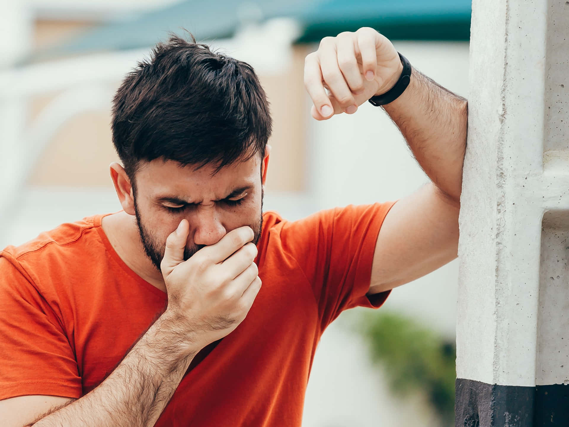 Nauseous Man In Orange Shirt Background