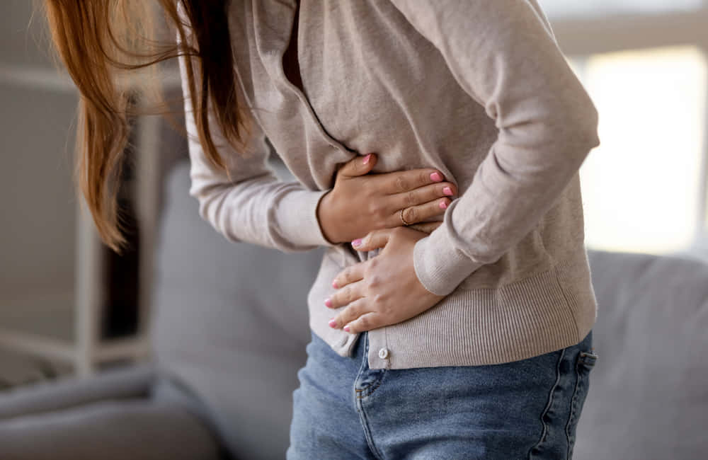 Nauseous Woman In Cream Cardigan