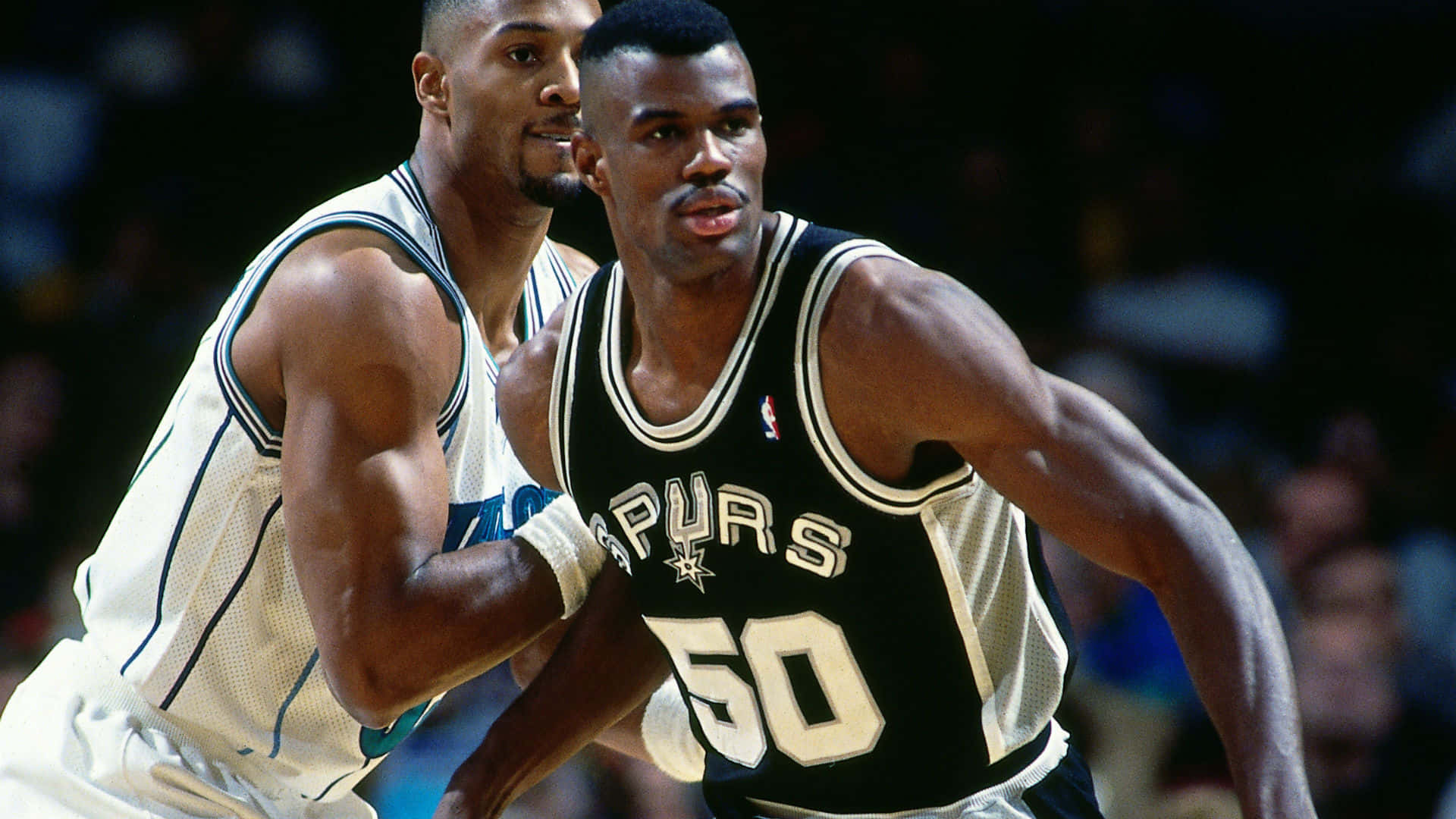 Nba Player David Robinson Blocking Alonzo Mourning Background