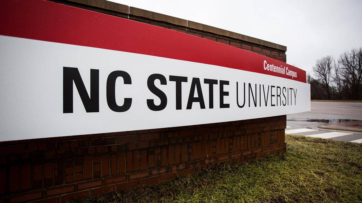 Nc State University's Iconic Red And White Signage Background