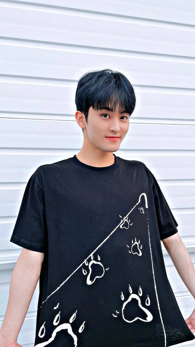 Nct 127's Mark Leaves A Lasting Impression In His Signature Footprint Shirt. Background