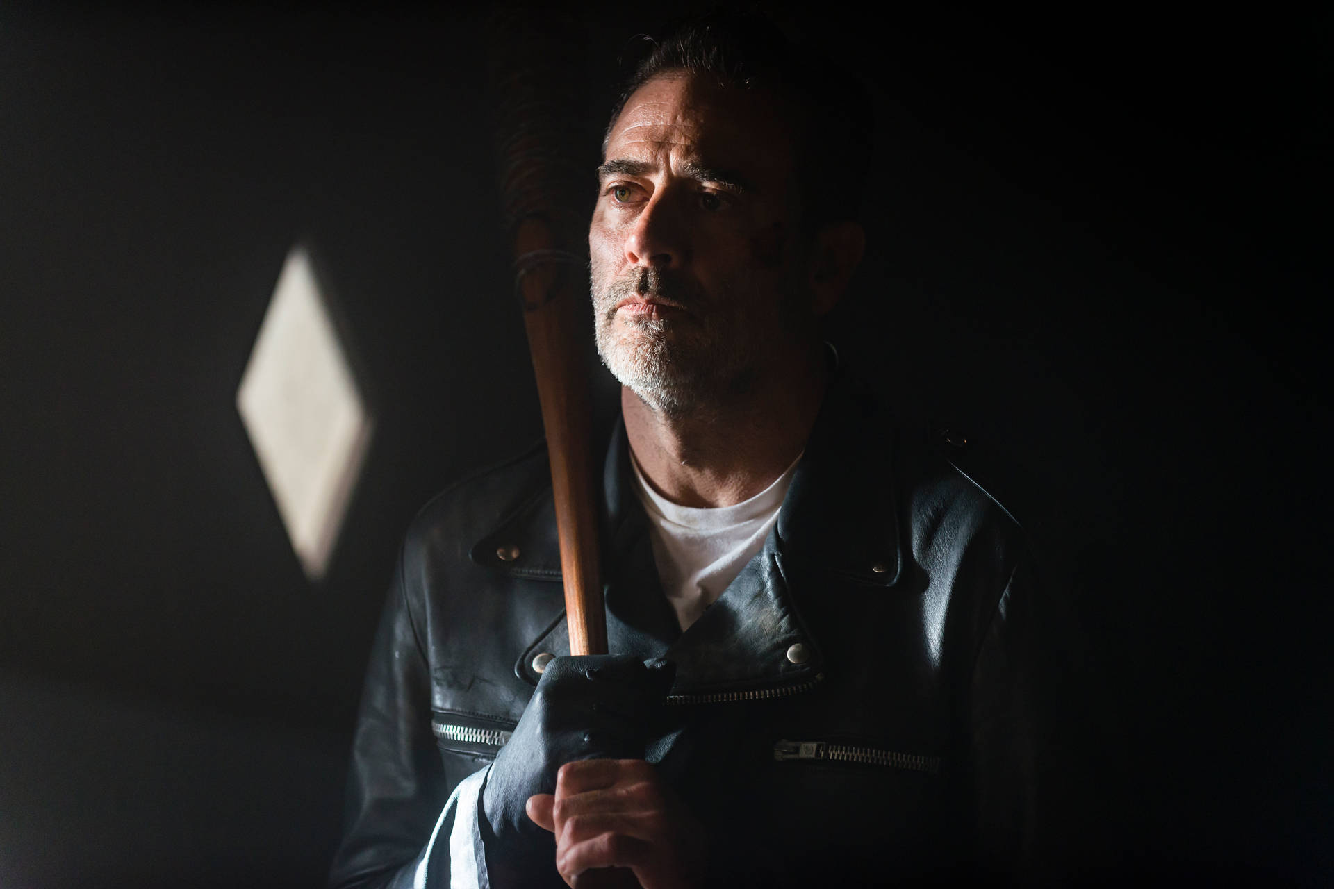 Negan In A Dimly Lit Room Background