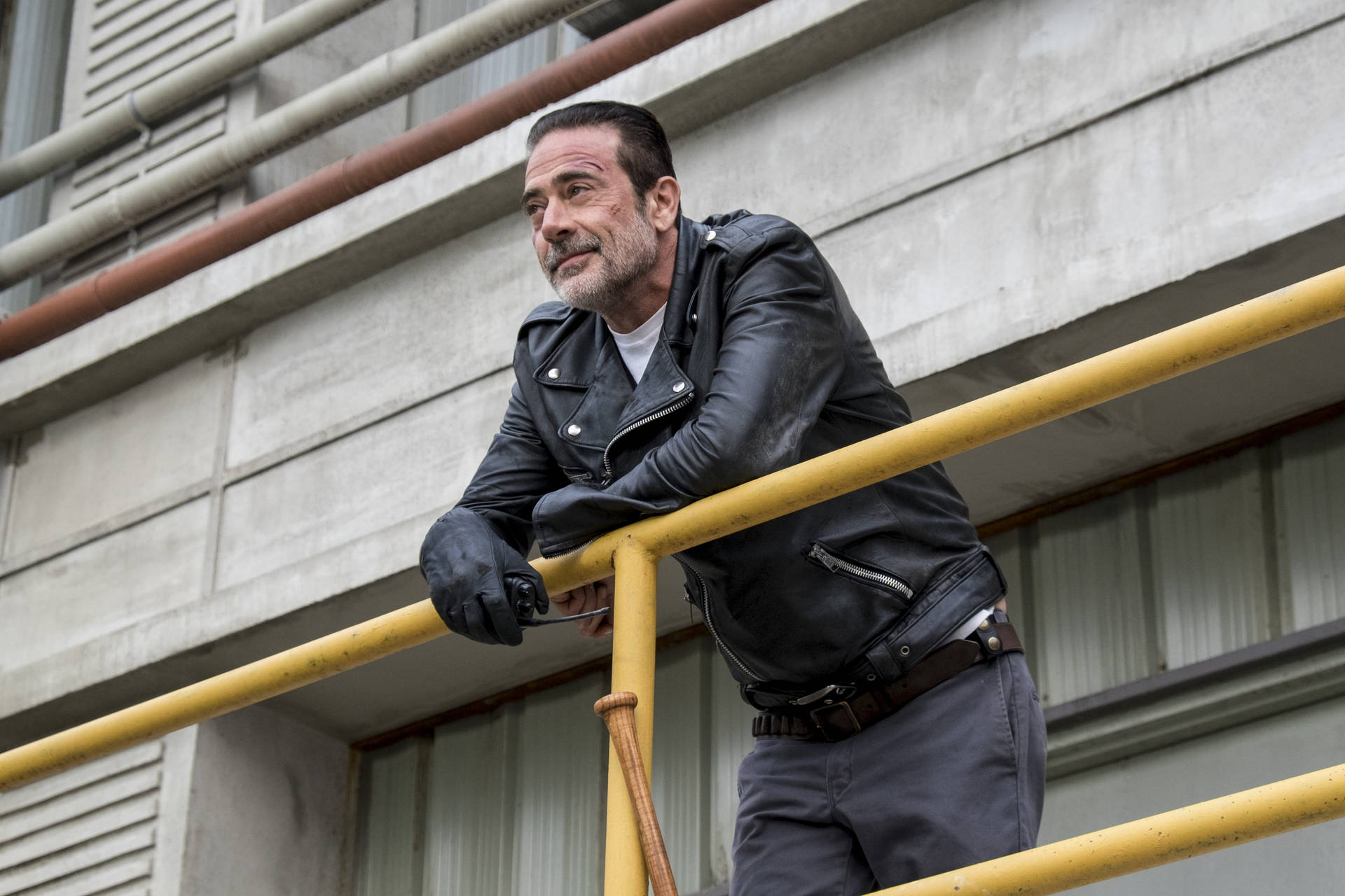 Negan Leaning On A Railing Background