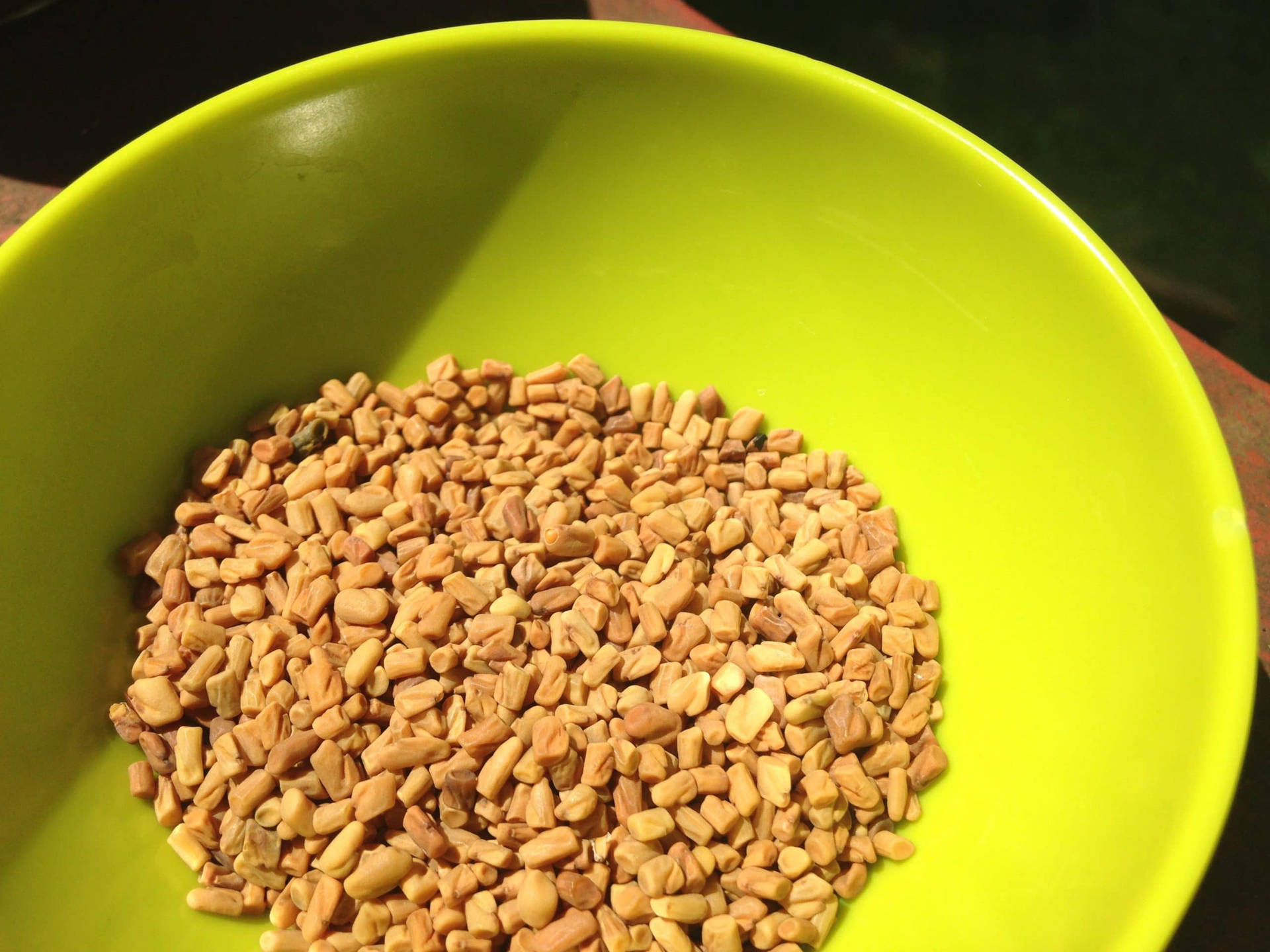 Neon Green Bowl Of Fenugreek Seeds Background