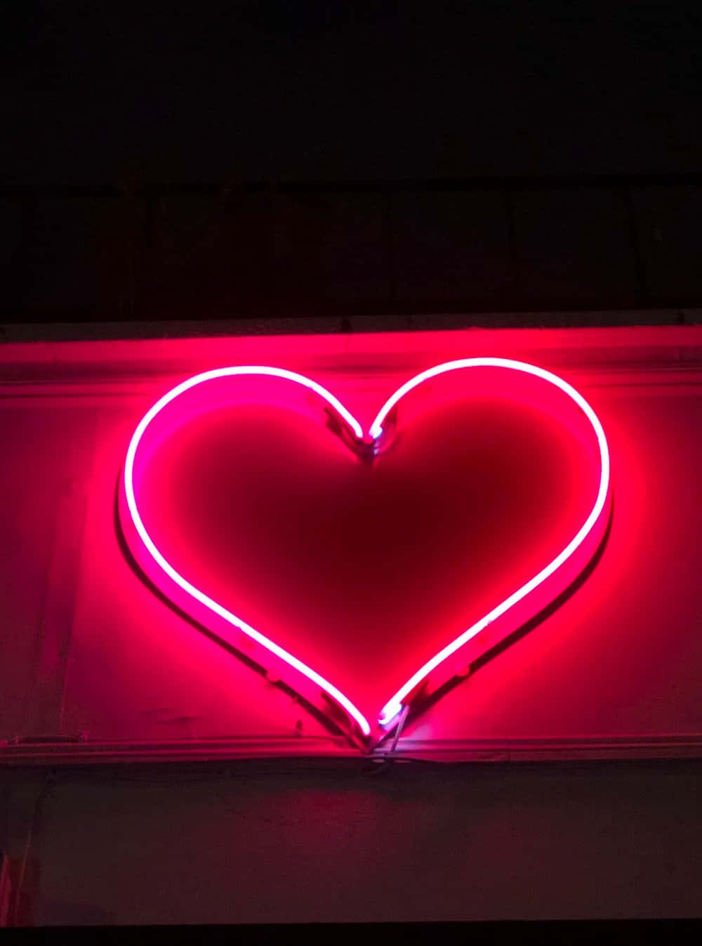 Neon Heart Lit In The Darkness Background