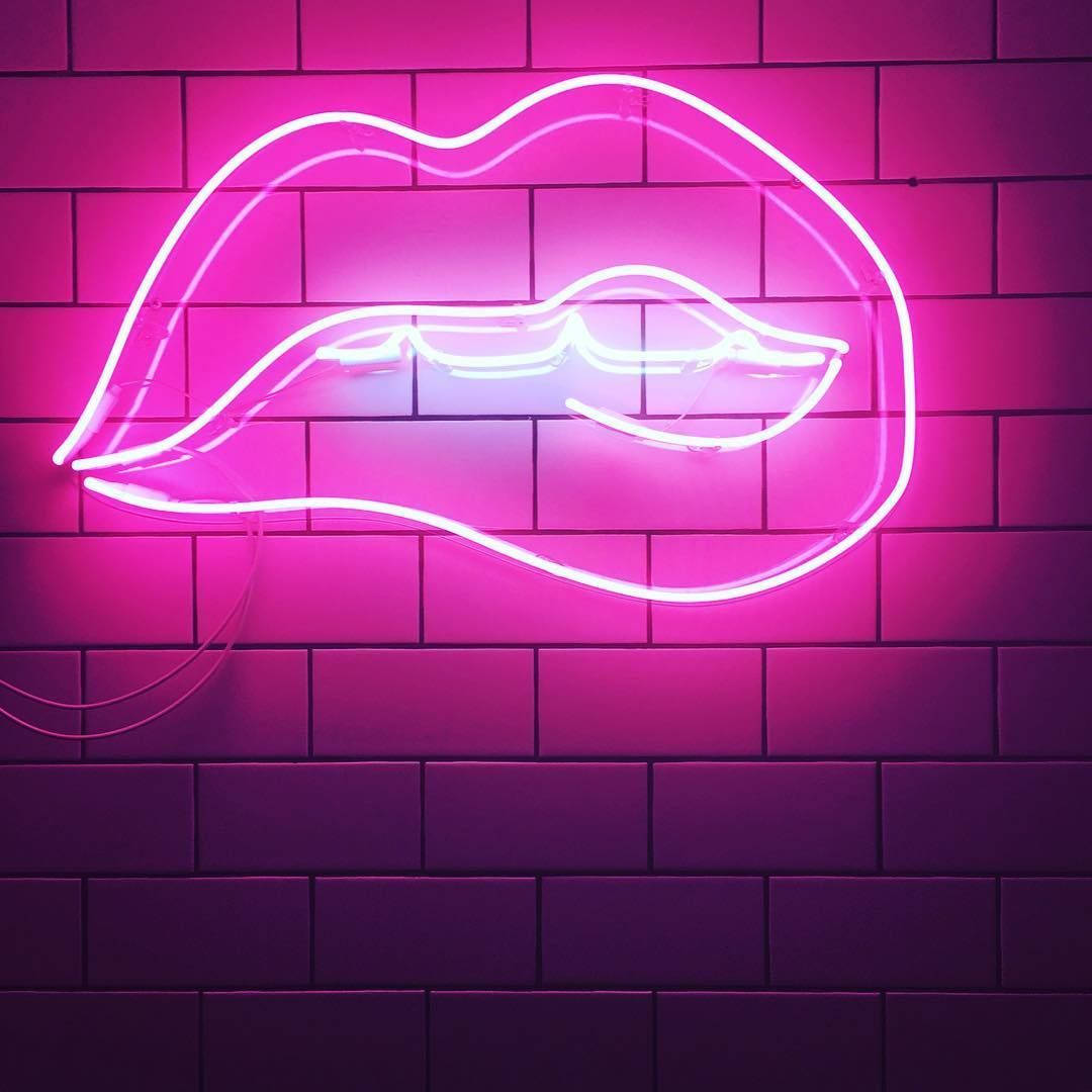 Neon Lips On Brick Wall Background