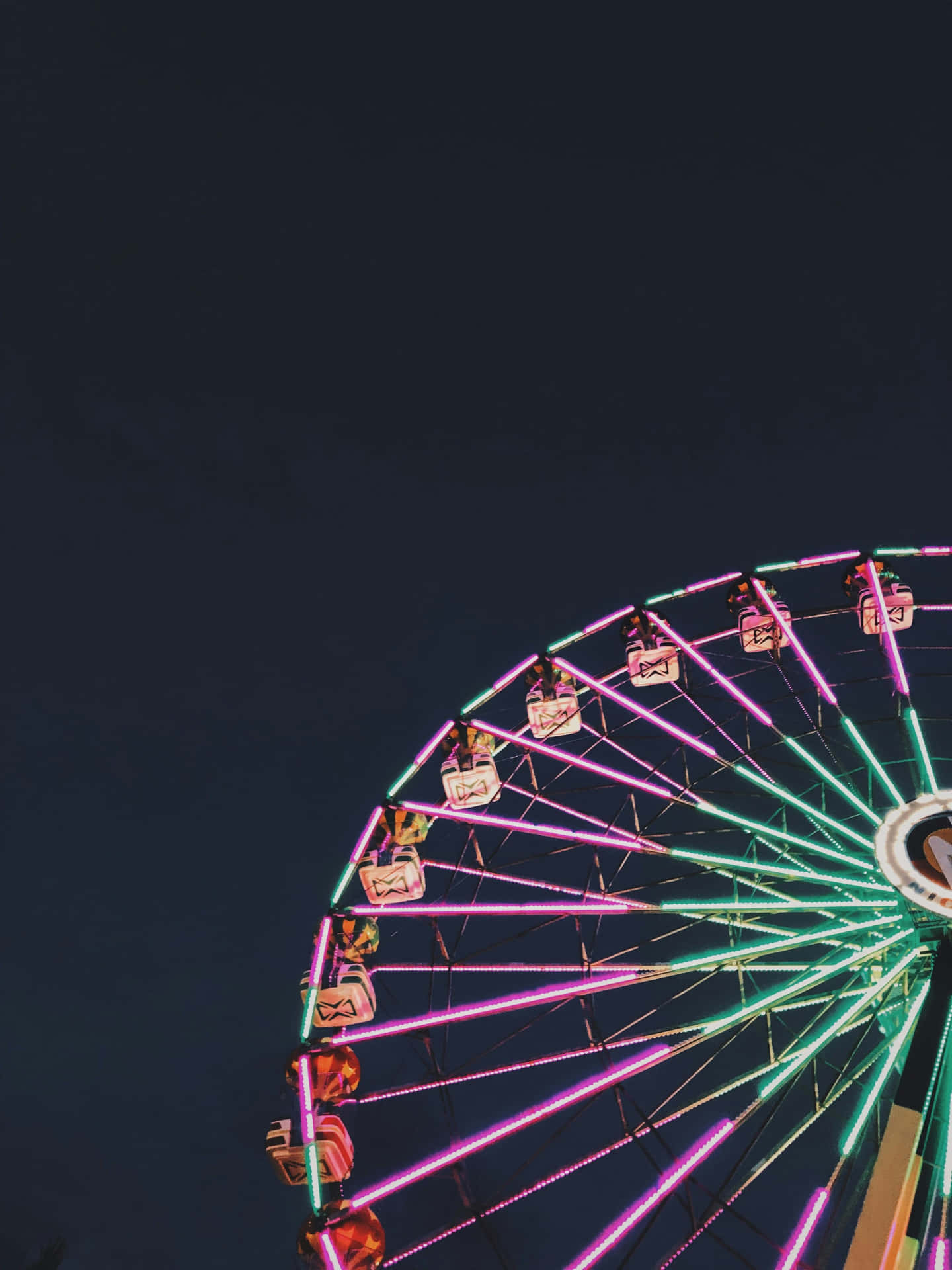 Neon Lit Ferris Wheelat Night Background
