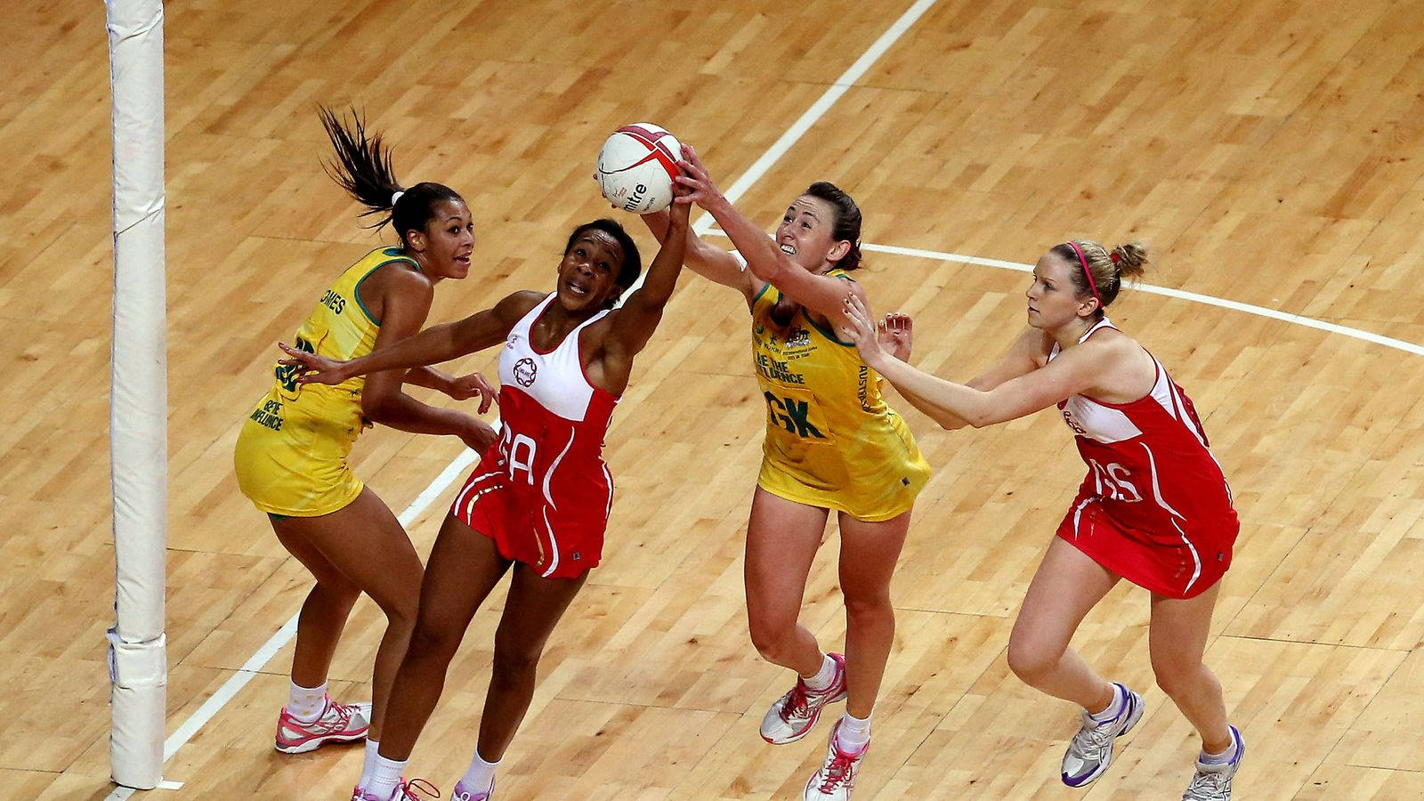 Netball Game Two Teams Grabbing Ball