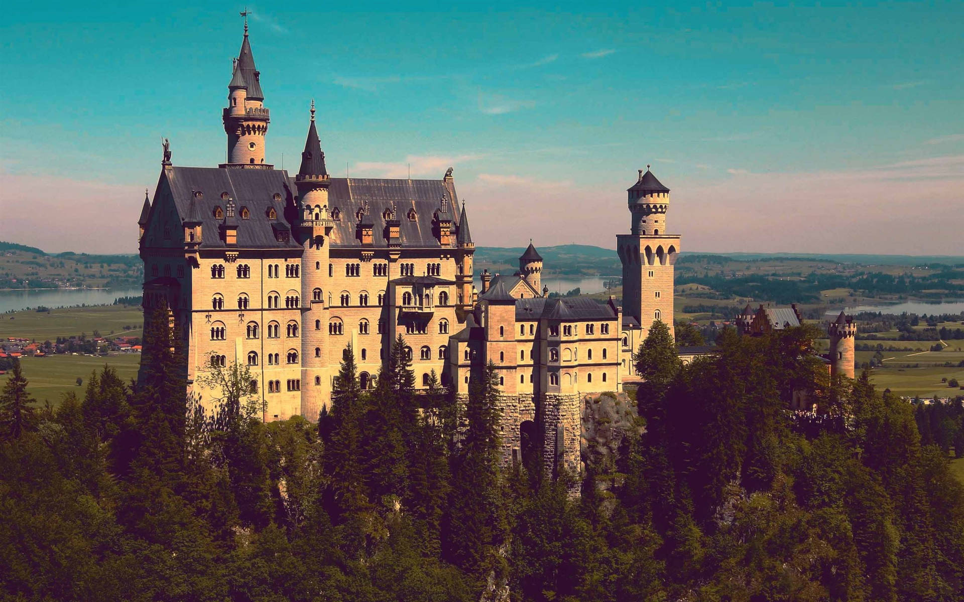 Neuschwanstein Castle Bathed In Sunlight Background