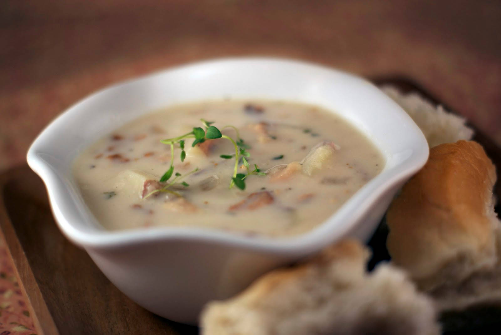 New England Clam Chowder And Pieces Of Bread Background