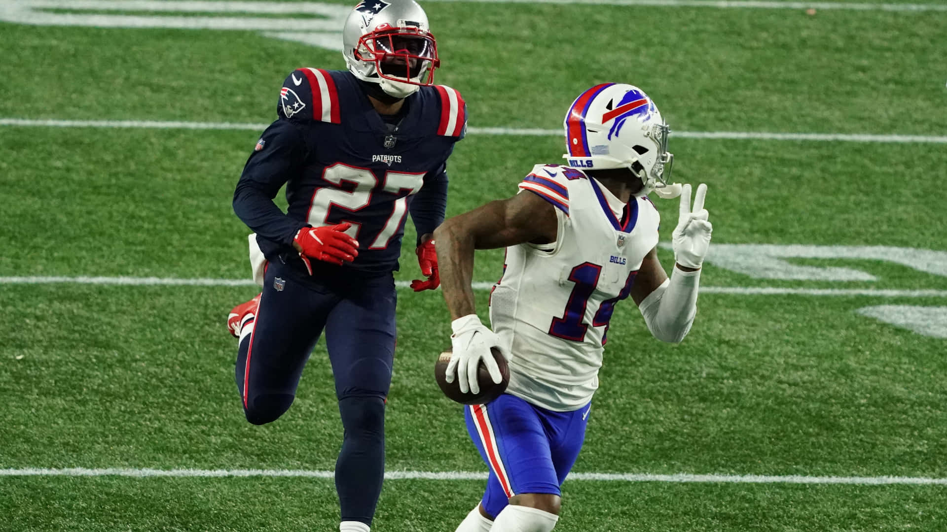 New England Patriots Cornerback Jc Jackson Running After Stephen Diggs Background