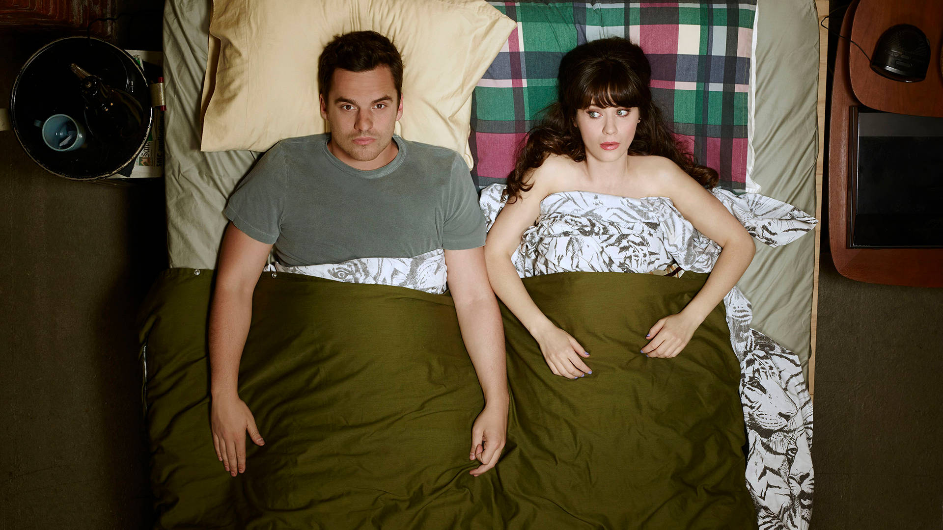 New Girl Nick And Jessica Lying On Bed Background