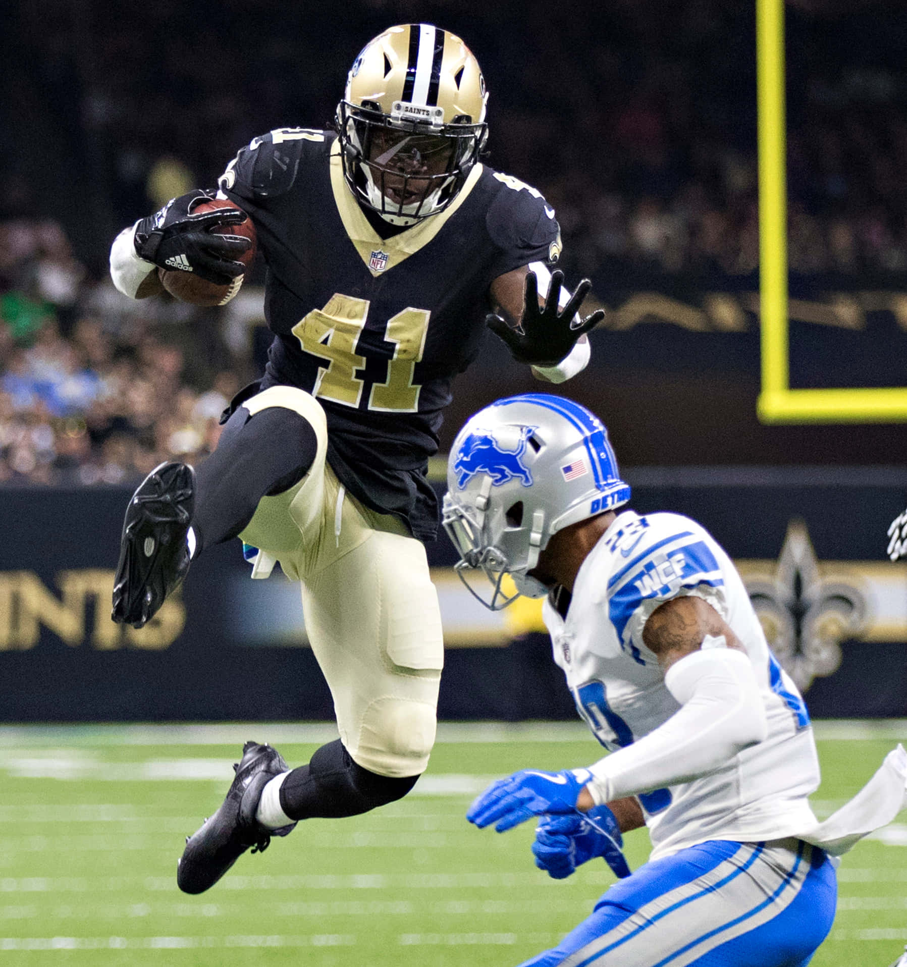 New Orleans Saints Star Alvin Kamara Runs The Ball Background