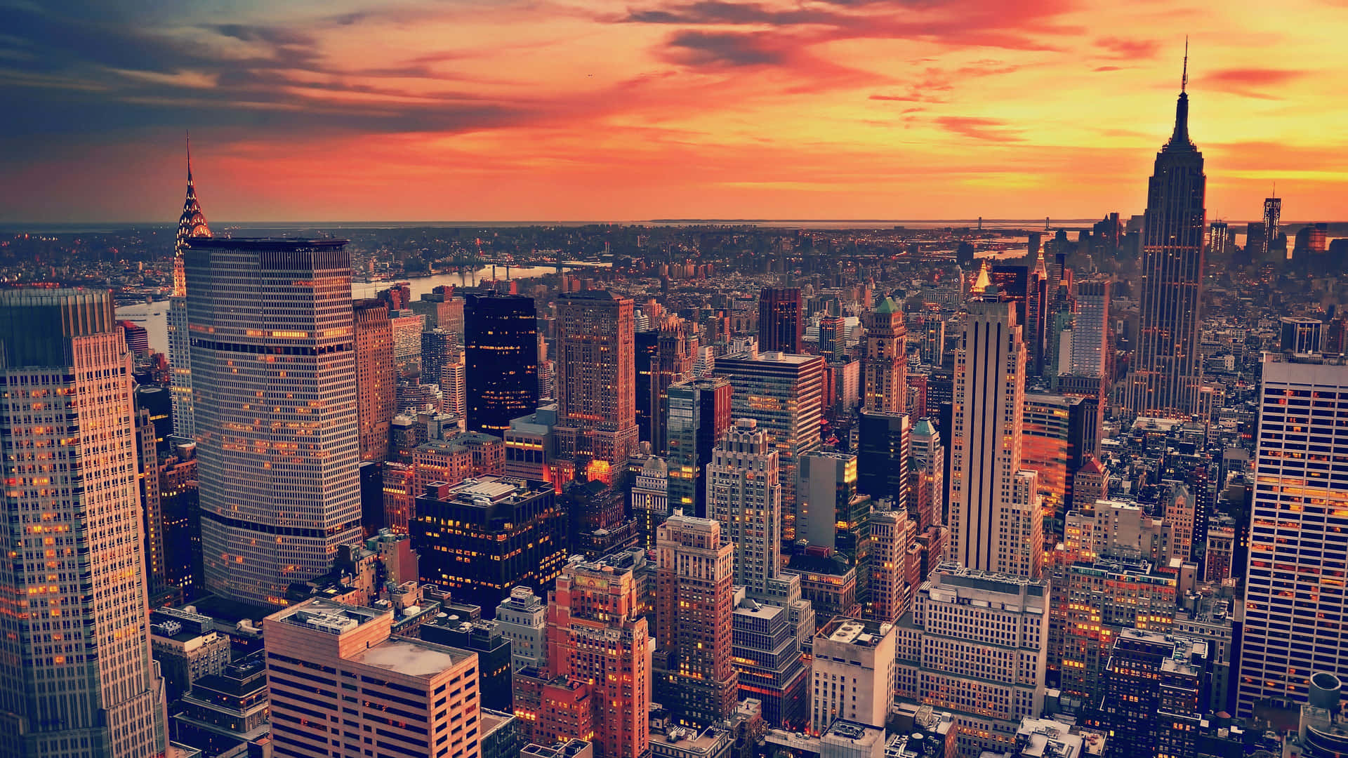 New York City Skyline Brightened By Evening Lights, Viewed From A Laptop Screen. Background