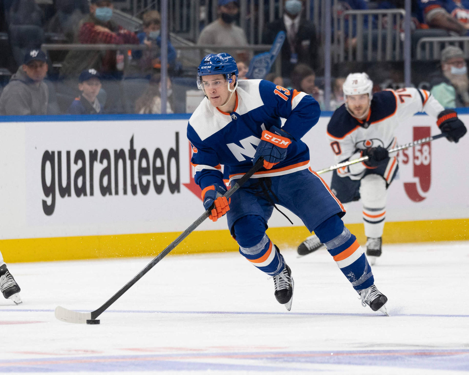 New York Islanders Ice Hockey Player Mathew Barzal In Action Background