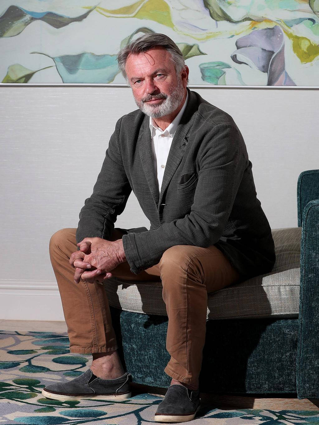 New Zealand Actor Sam Neill Sitting Portrait Background