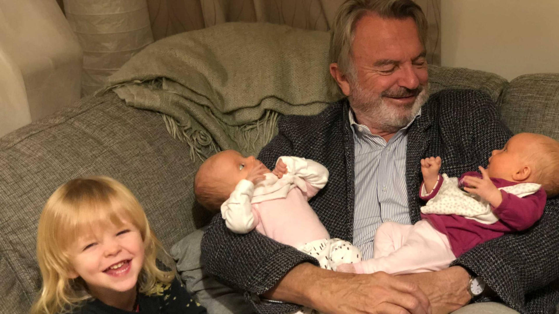 New Zealand Actor Sam Neill With Grandkids Background