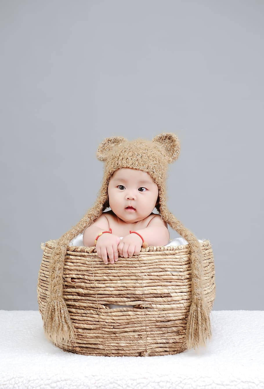 Newborn Child In A Knitted Basket