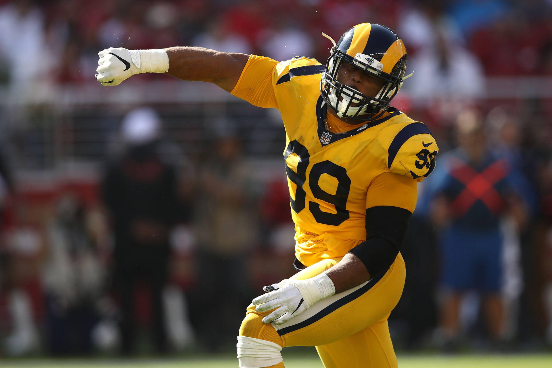Nfl Athlete Aaron Donald Yellow Jersey Background