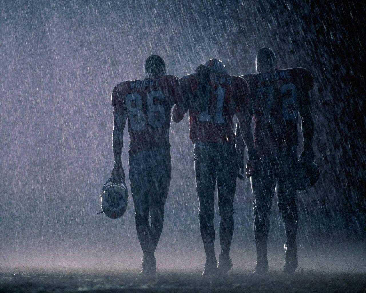 Nfl Football Players In The Rain Background