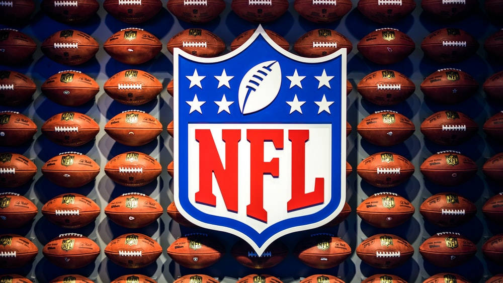Nfl Logo With Footballs Background