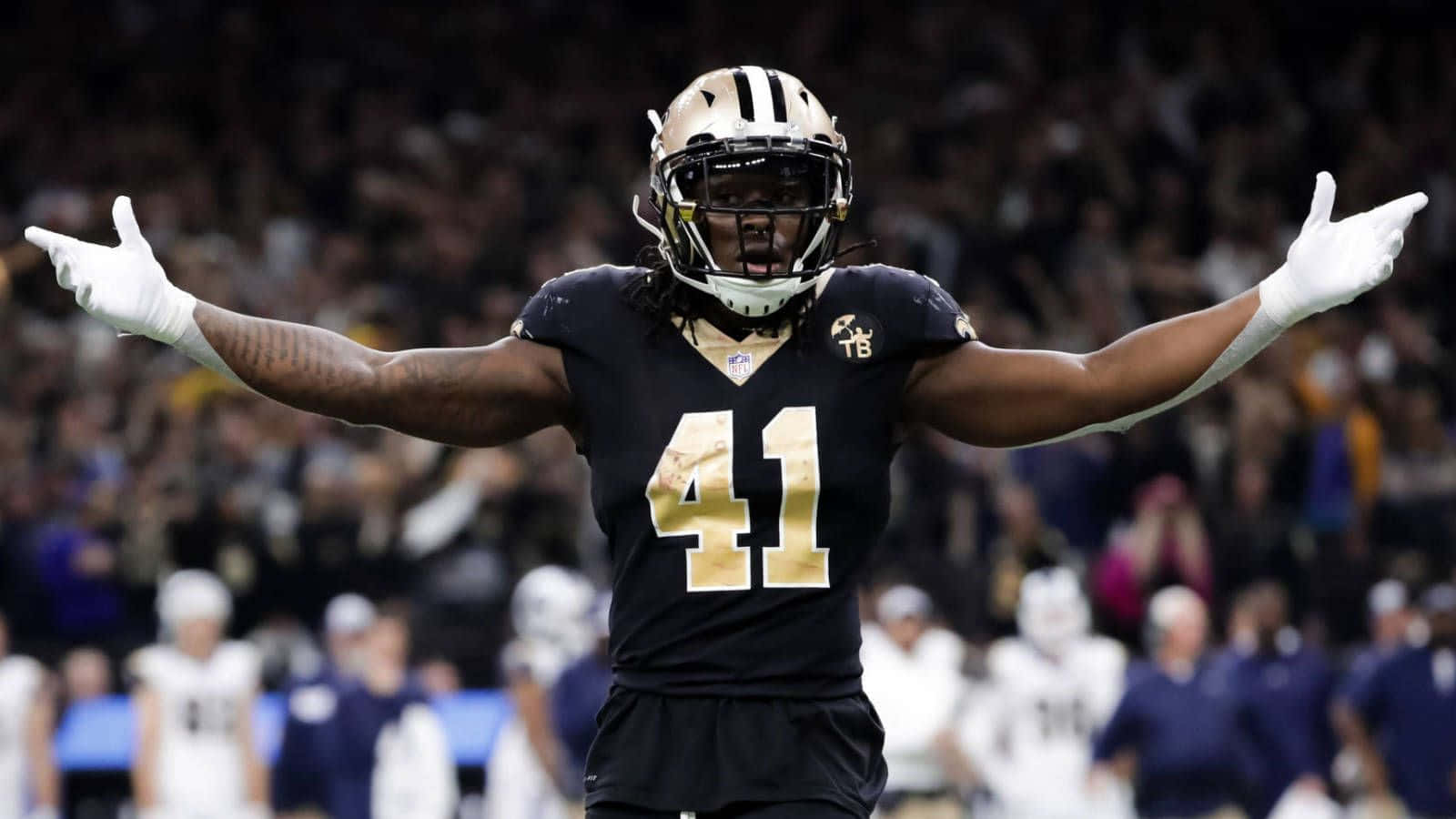 Nfl Running Back Alvin Kamara Takes Off With The Ball Background