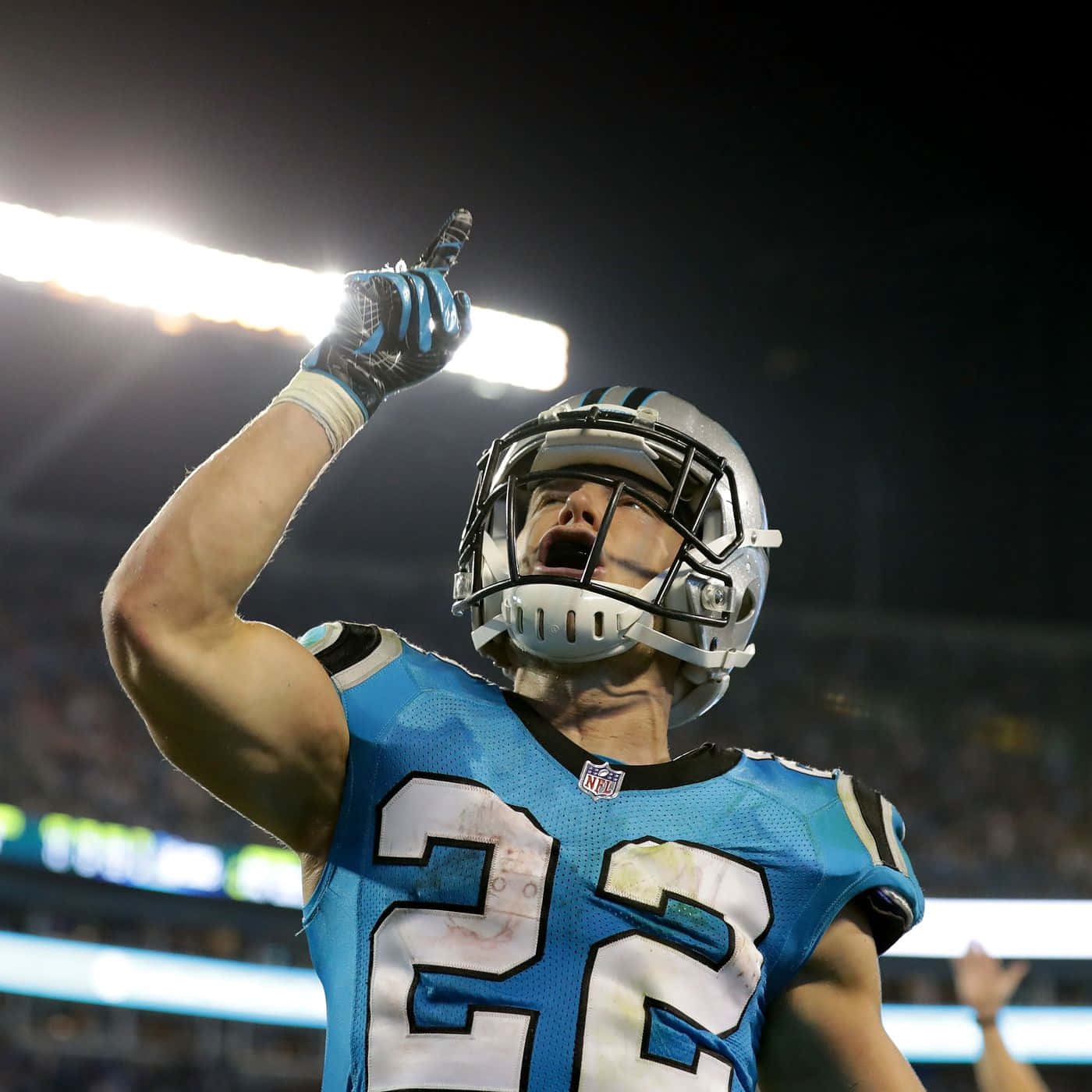 Nfl Running Back Christian Mccaffrey Charging Down Field Background