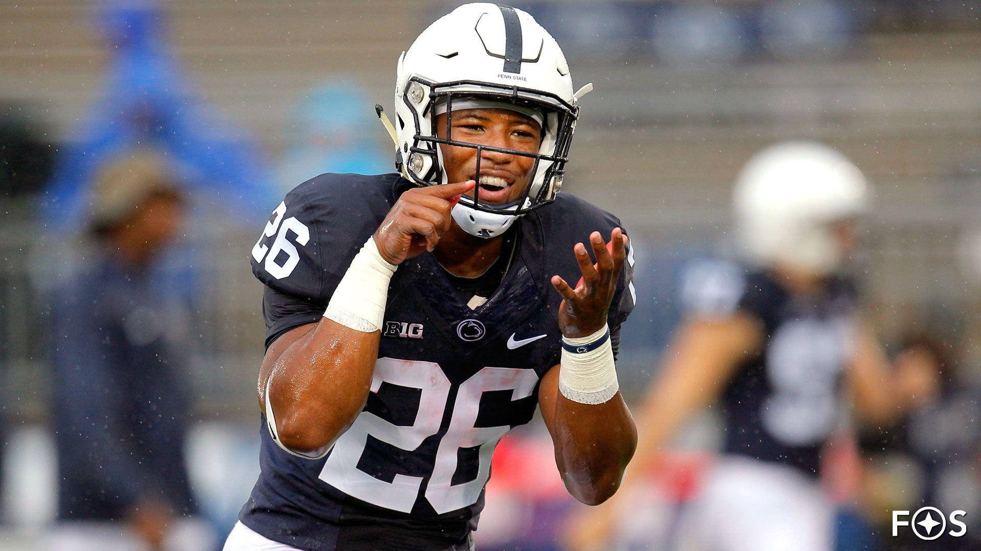 Nfl Star Saquon Barkley Running For The End Zone Background