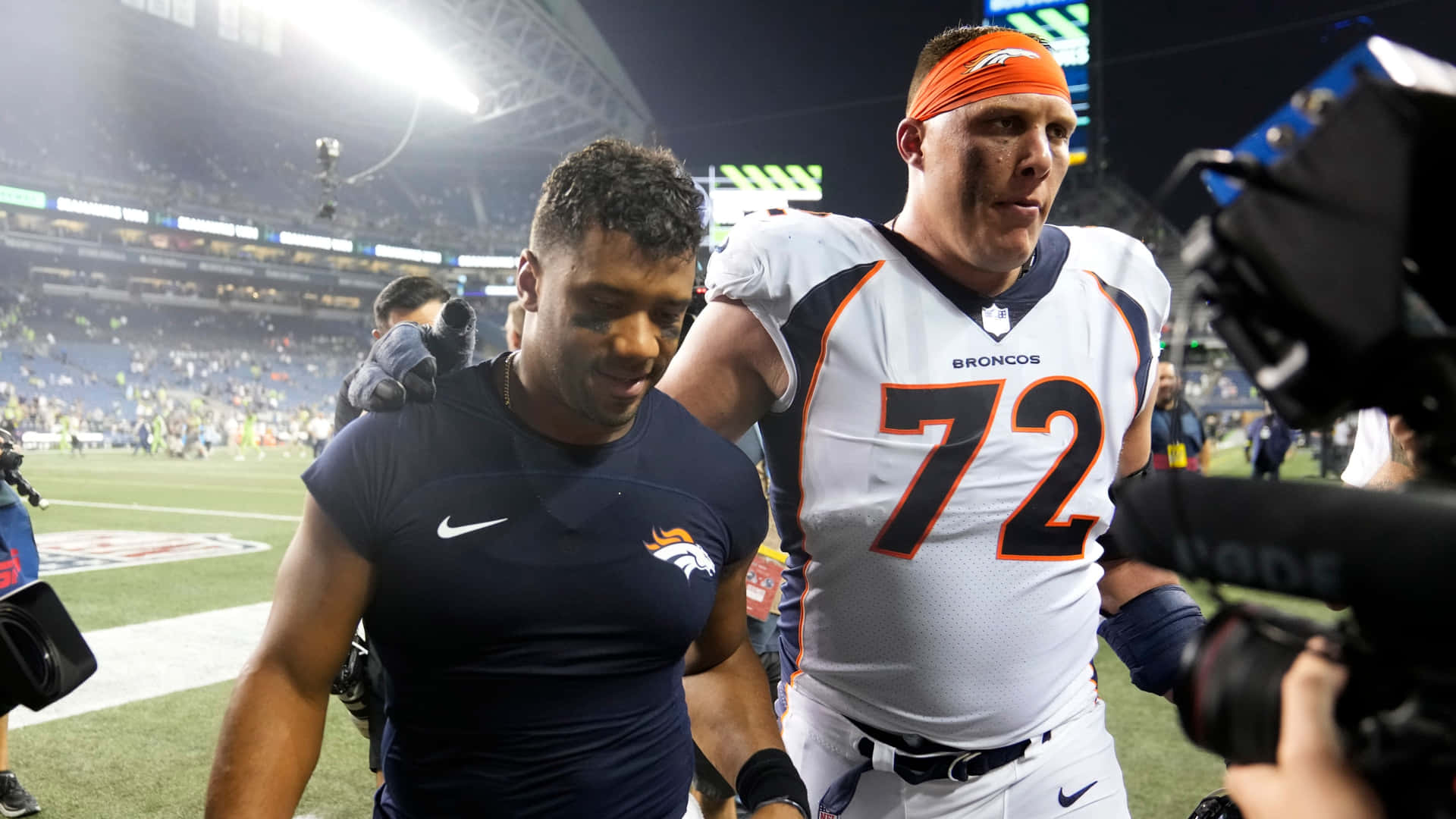 Nfl Stars In Action - Russell Wilson And Garett Bolles Background