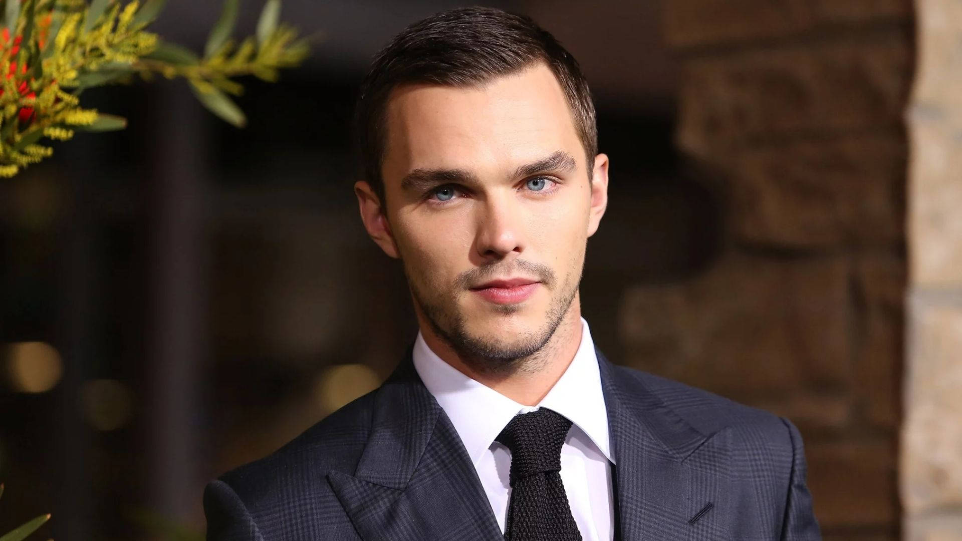 Nicholas Hoult Looking Dapper In A Sharp Suit Background