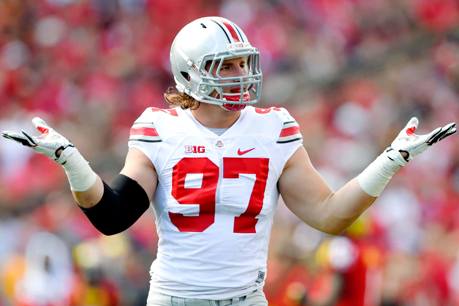 Nick Bosa Ready For Action In The 49ers' Red And Gold Background