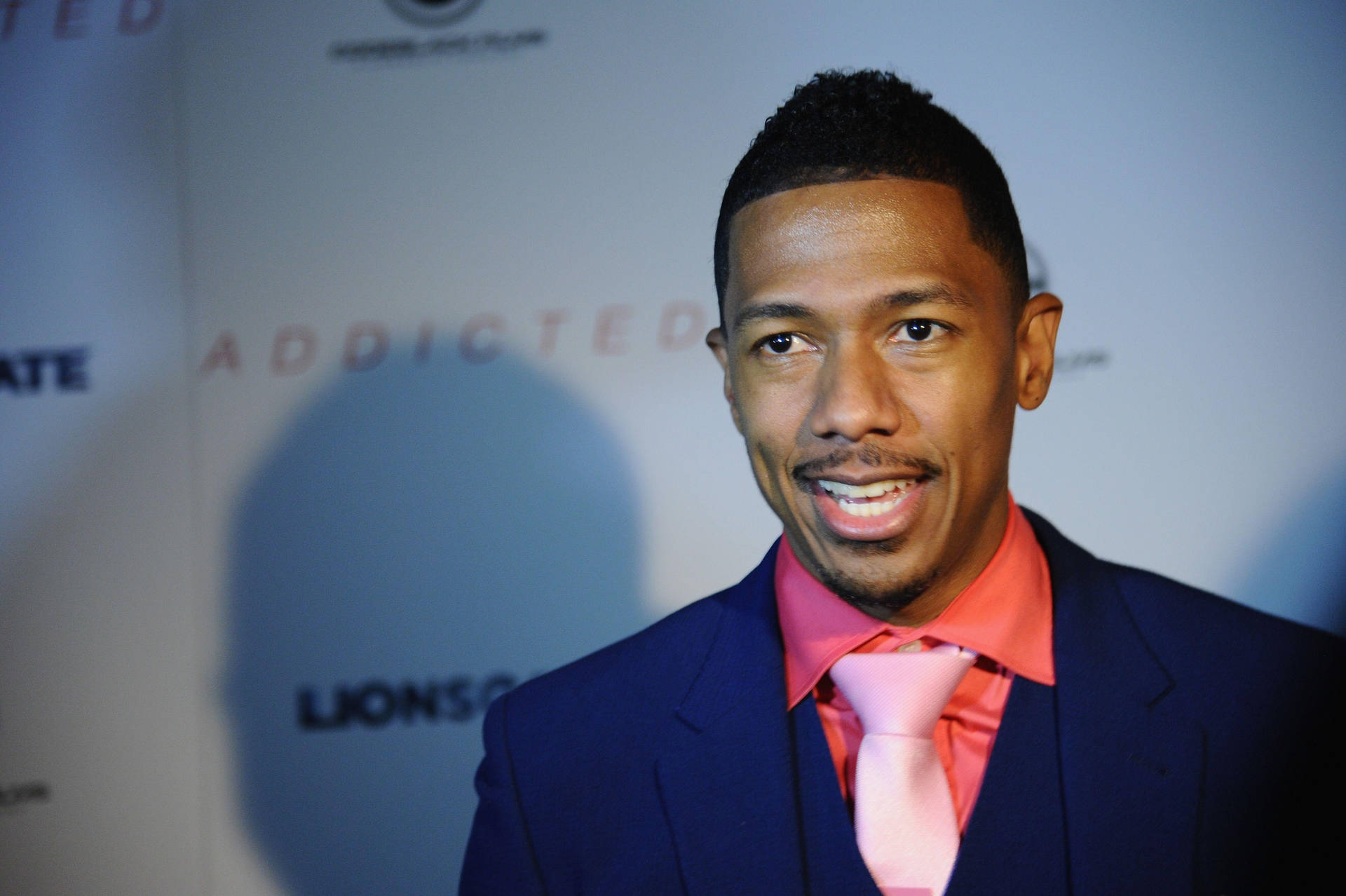 Nick Cannon Talking On Red Carpet Background