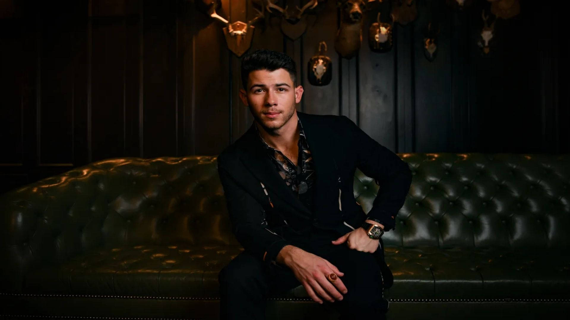 Nick Jonas On Elegant Couch Background