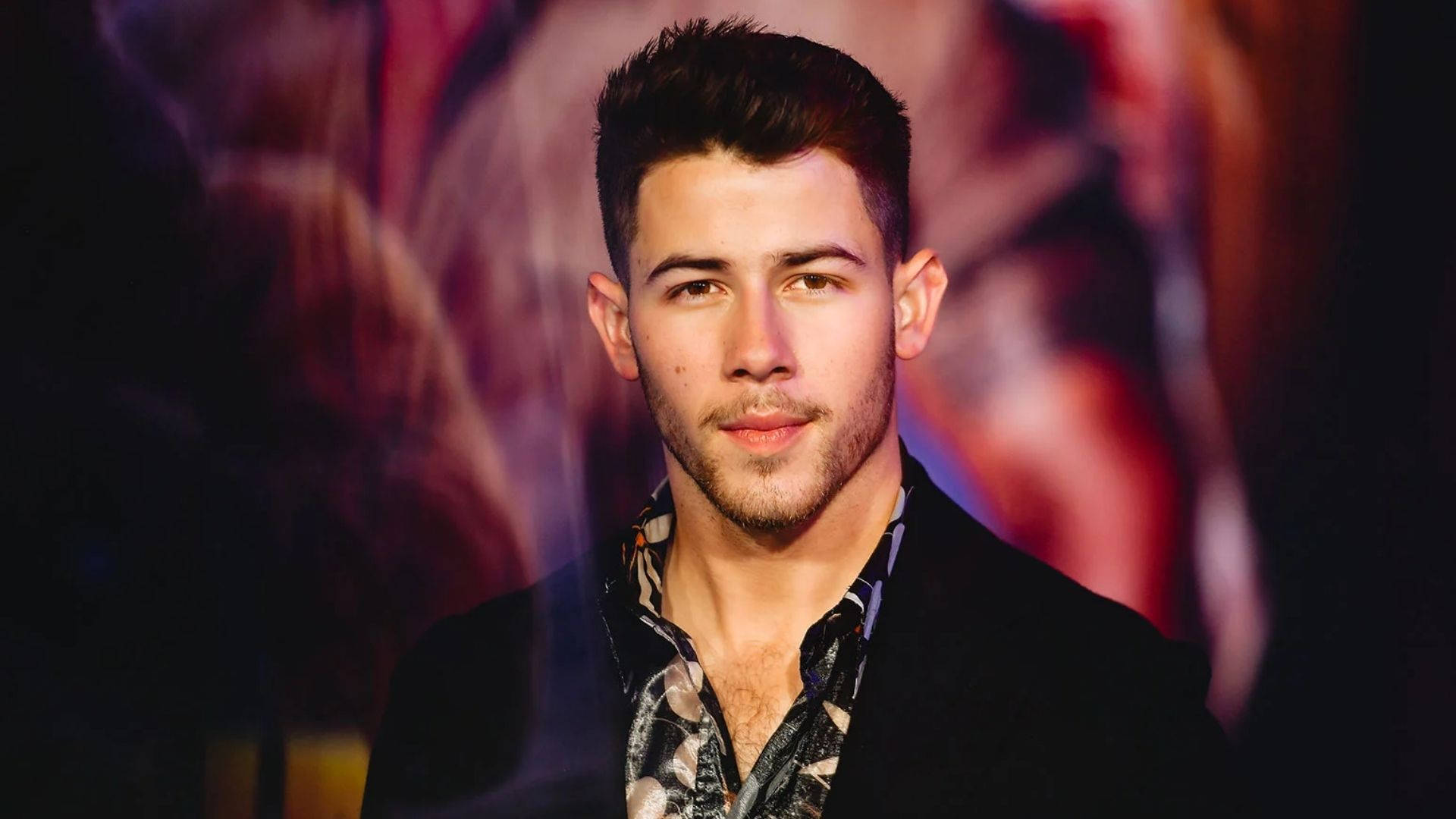 Nick Jonas With Colorful Lights Background