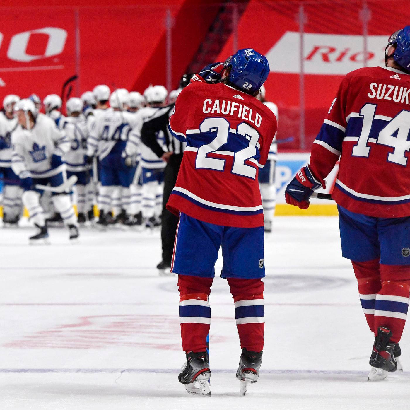 Nick Suzuki And Cole Caufield Against Toronto Maple Leafs Background