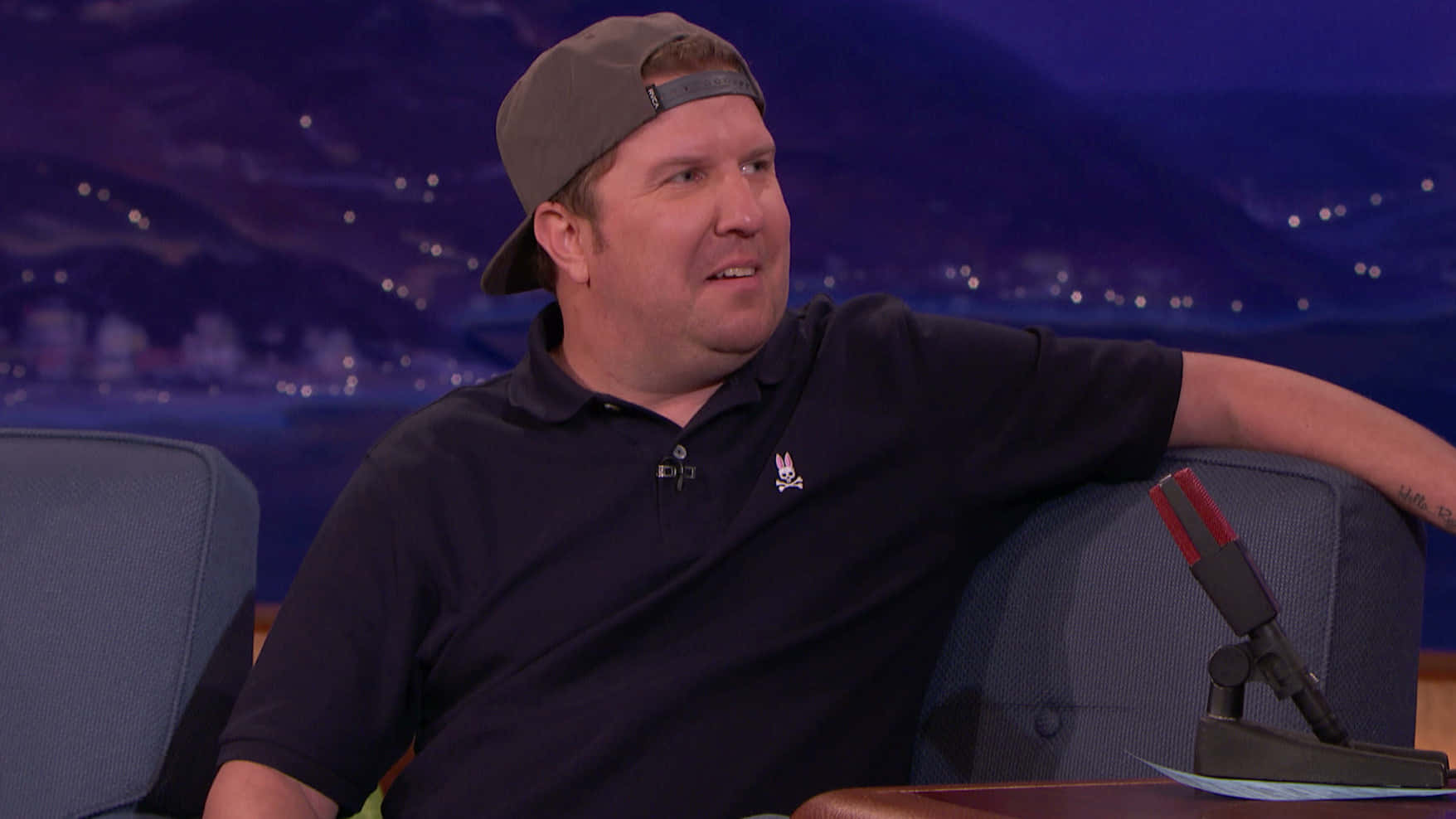 Nick Swardson, Grinning In Front Of The Camera. Background