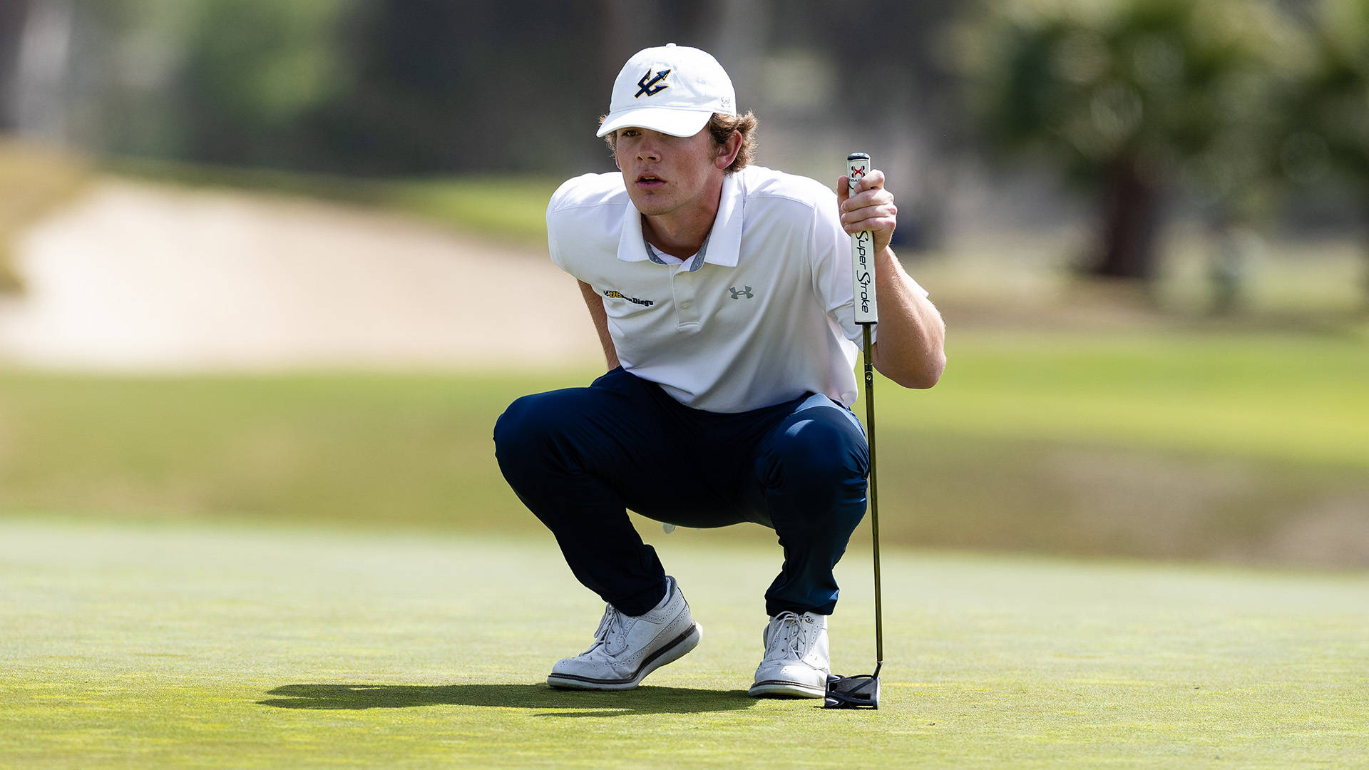 Nick Watney Expertly Swings His Golf Club On The Golf Course. Background