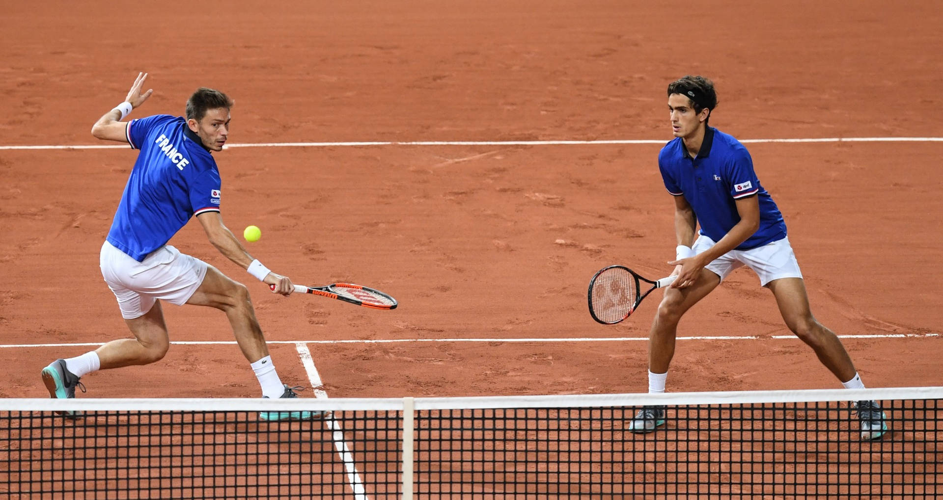 Nicolas Mahut Engaged In A Fierce Tennis Doubles Match