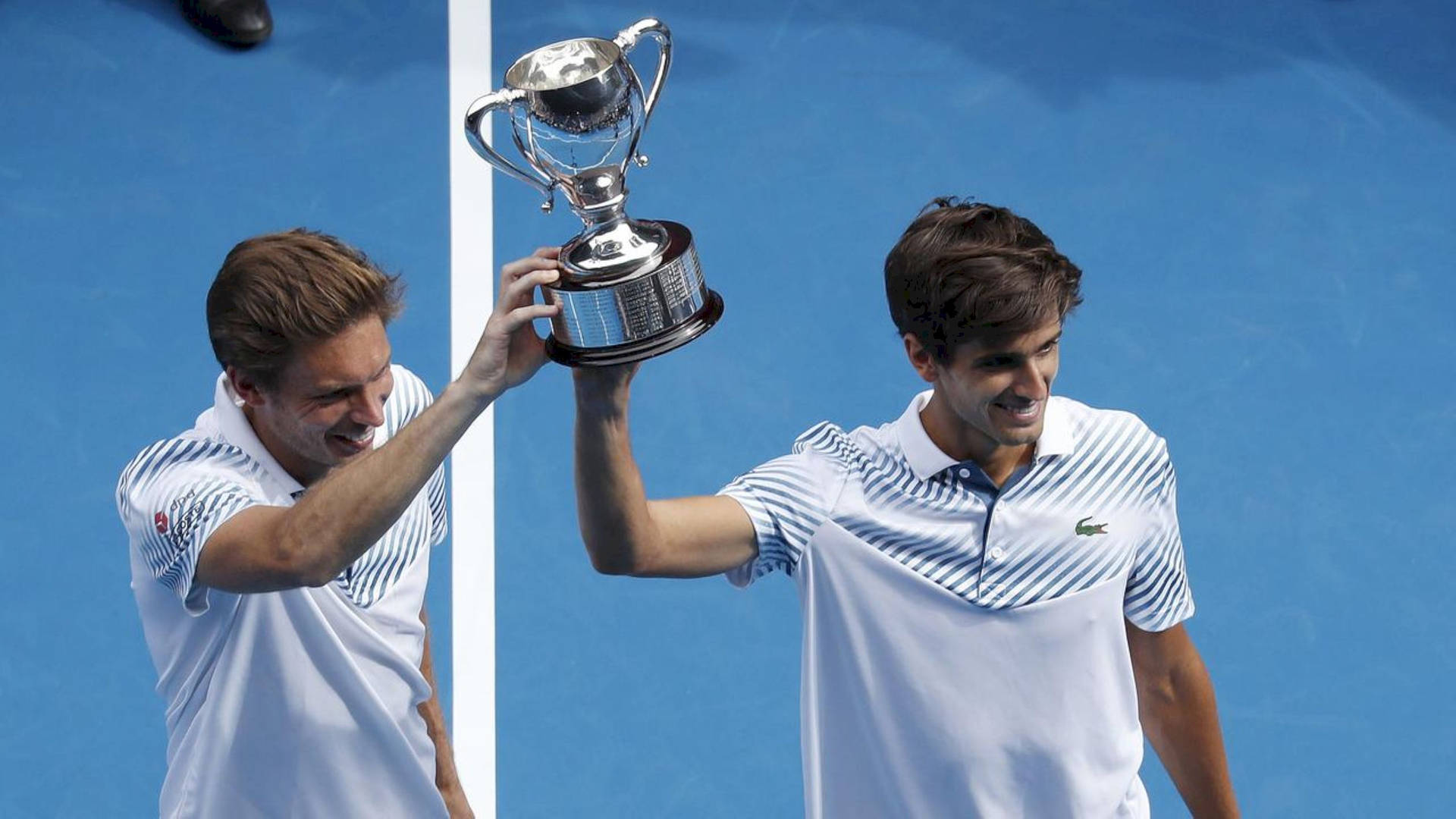 Nicolas Mahut Holding Up Trophy