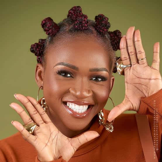 Nigerian Woman Emphasizing Smile Background