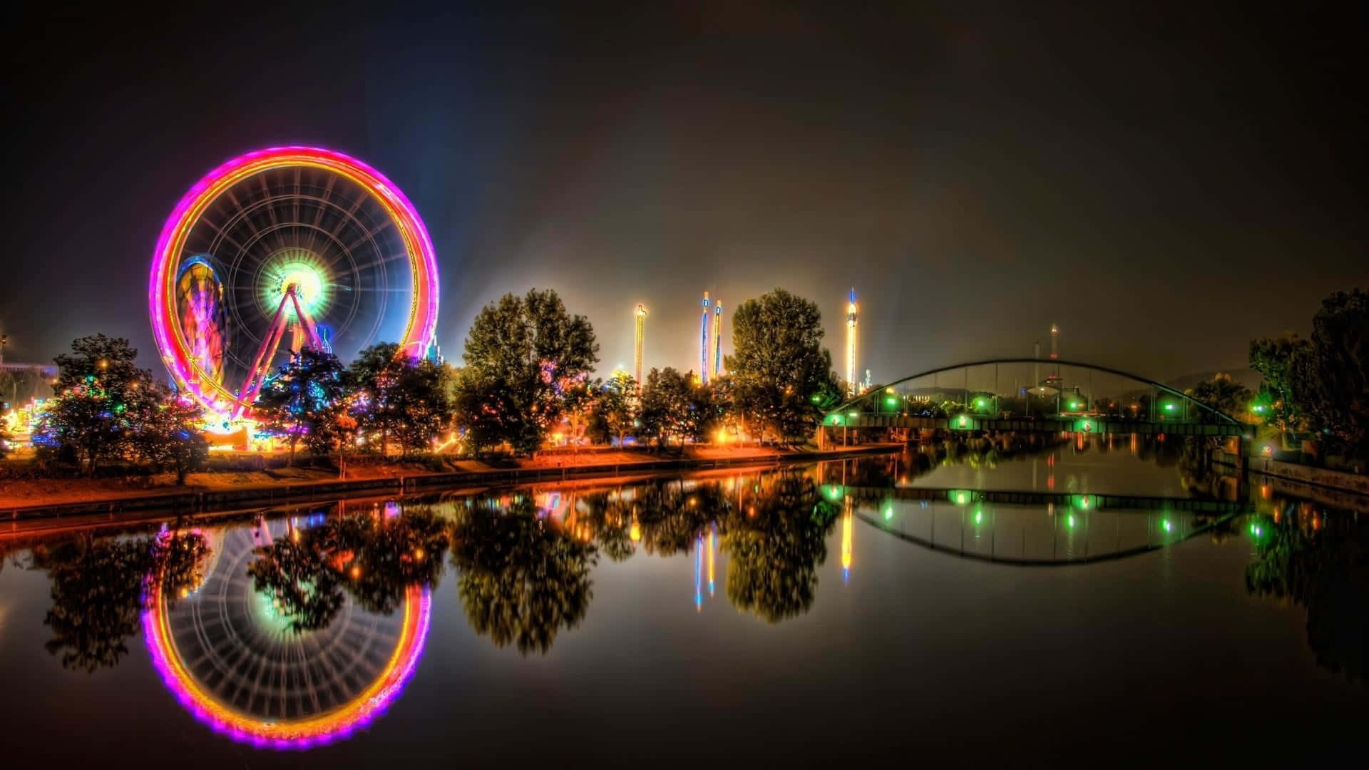 Nighttime Ferris Wheeland Reflections Background