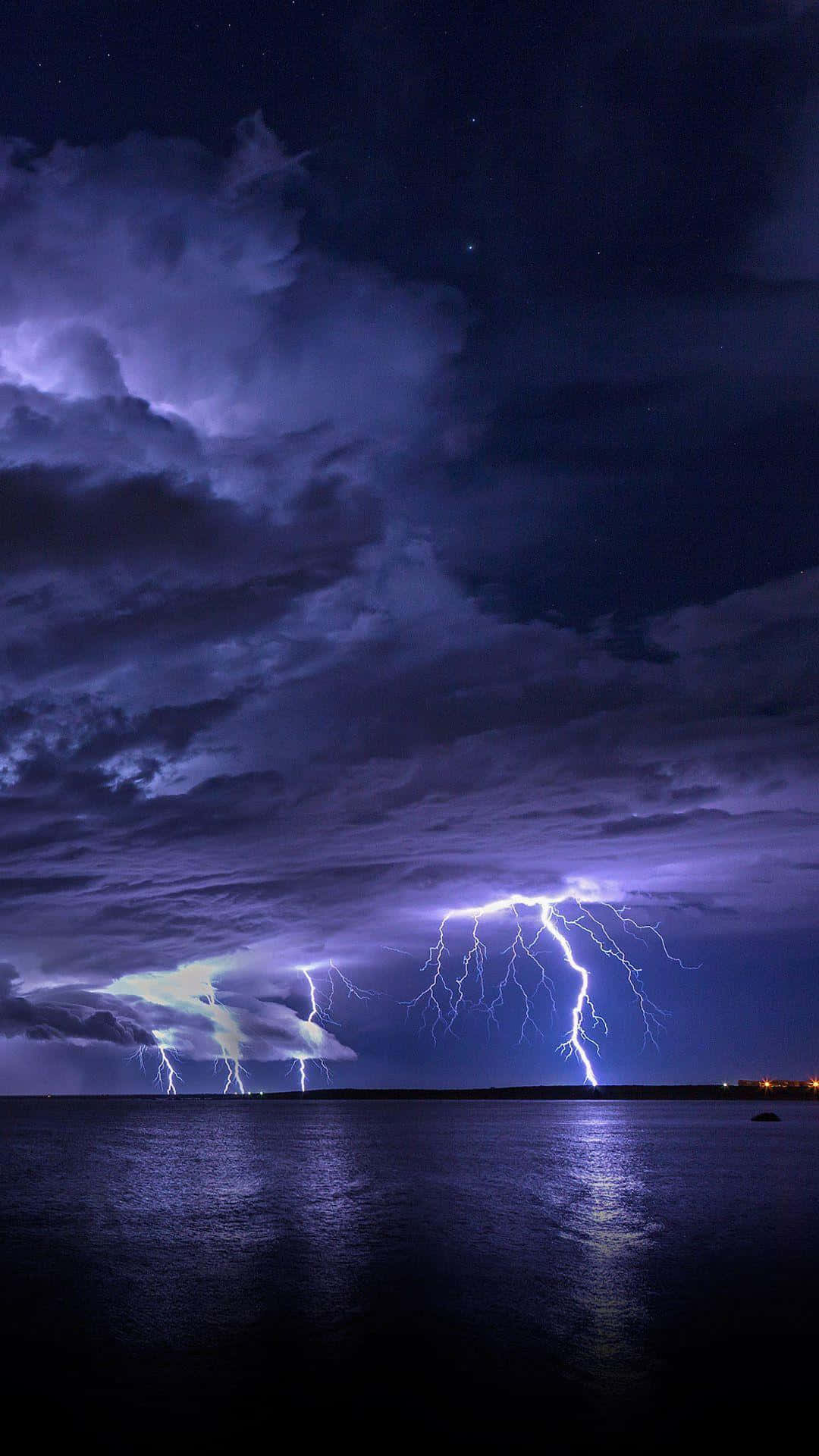 Nighttime Lightning Over Ocean Background