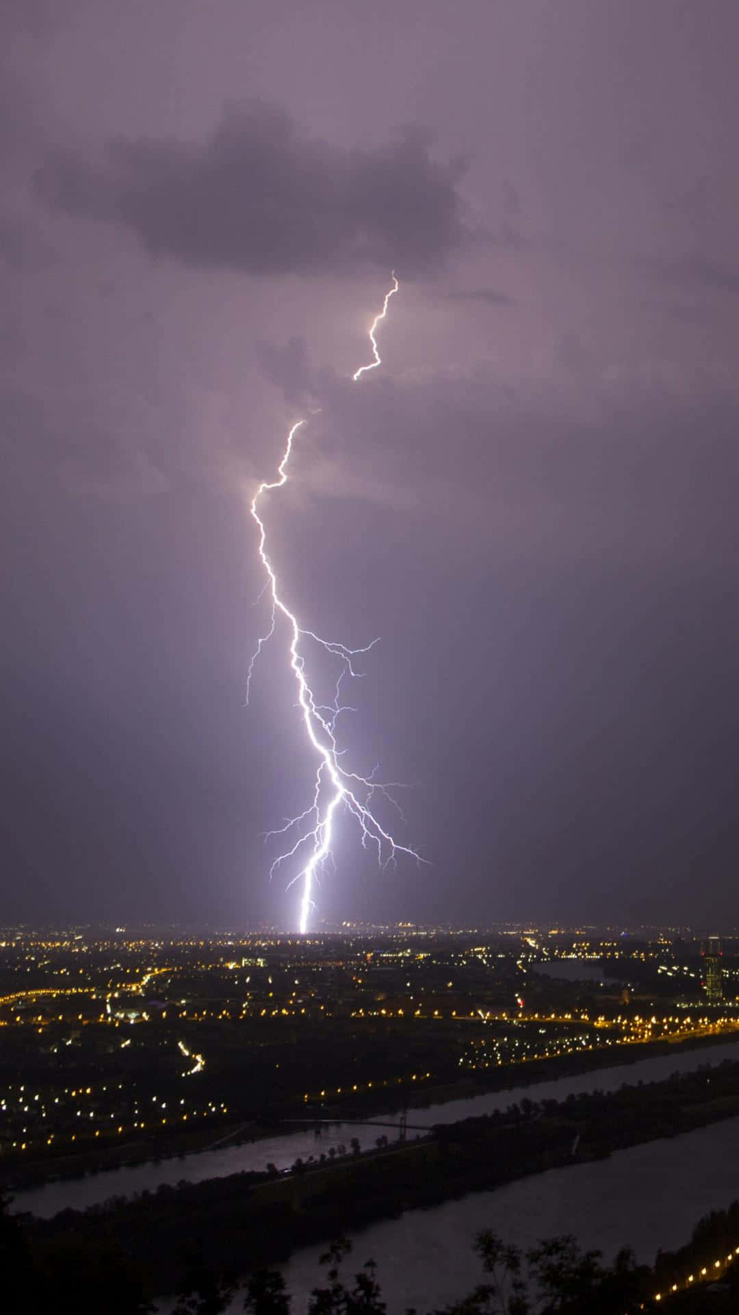 Nighttime Lightning Strike Over Cityscape