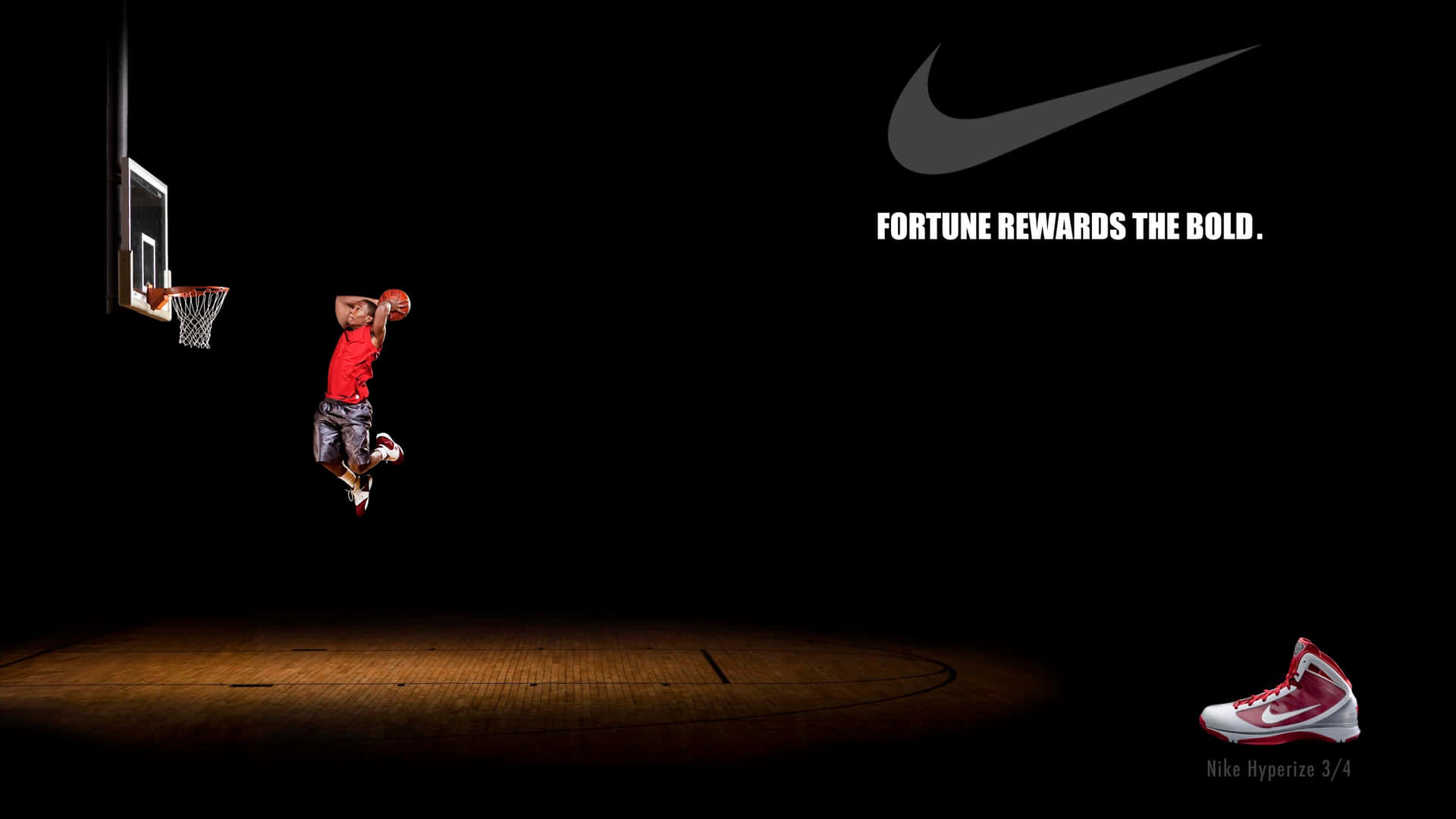 Nike Basketball Player Dunks A Basketball In The Dark Background