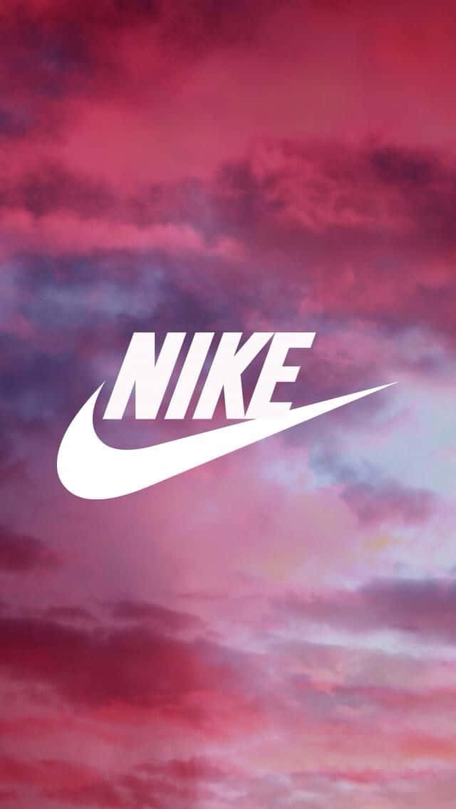 Nike Logo On A Pink Sky With Clouds Background
